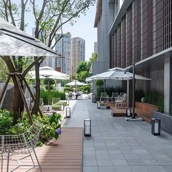 Square LED landscape light mounted in garden patio