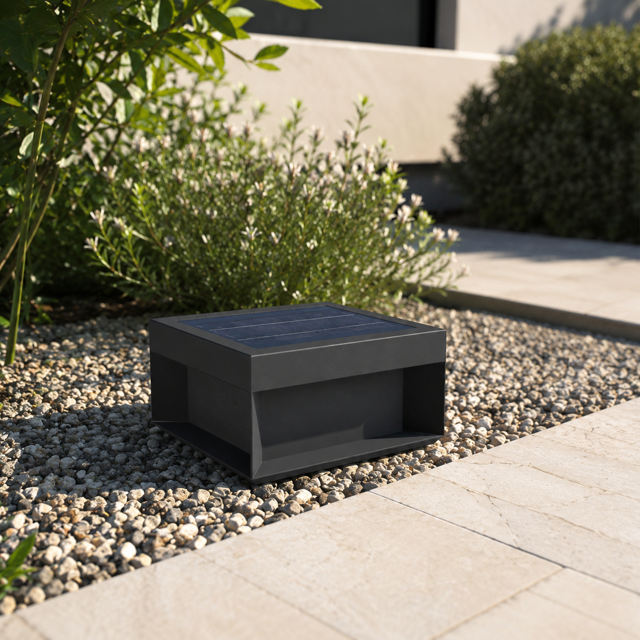 Alcacer solar box light resting on gravel ground beside paved path in daylight