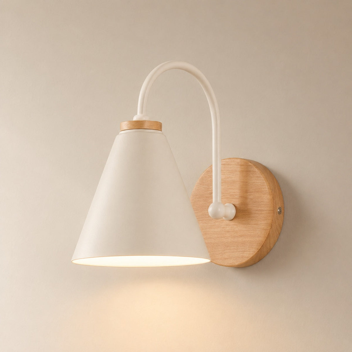 Alenquer wall sconce in white with solid wood backplate, lit warm on a beige wall