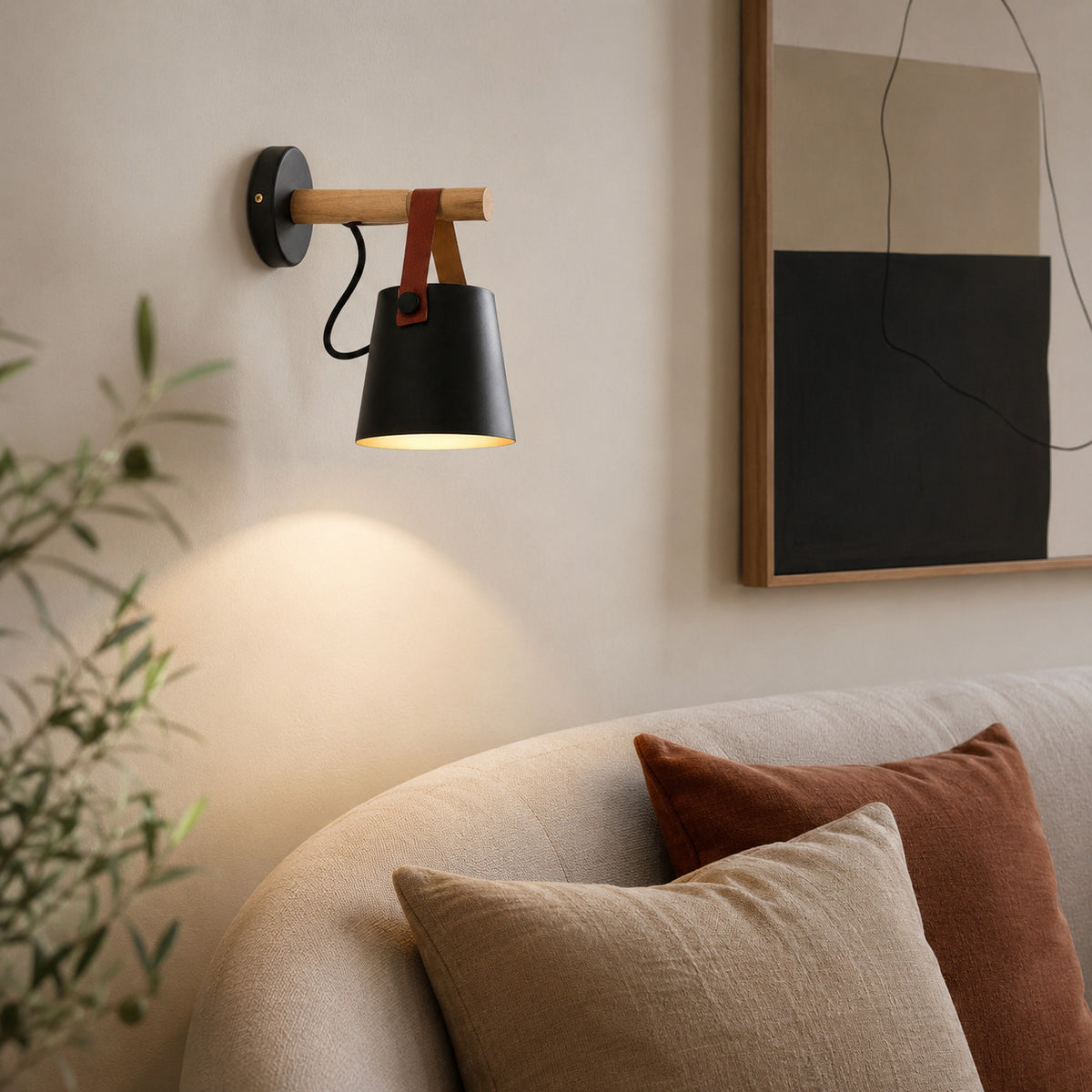 Alfusqueiro sconce in black above a curved sofa in a Scandinavian living room