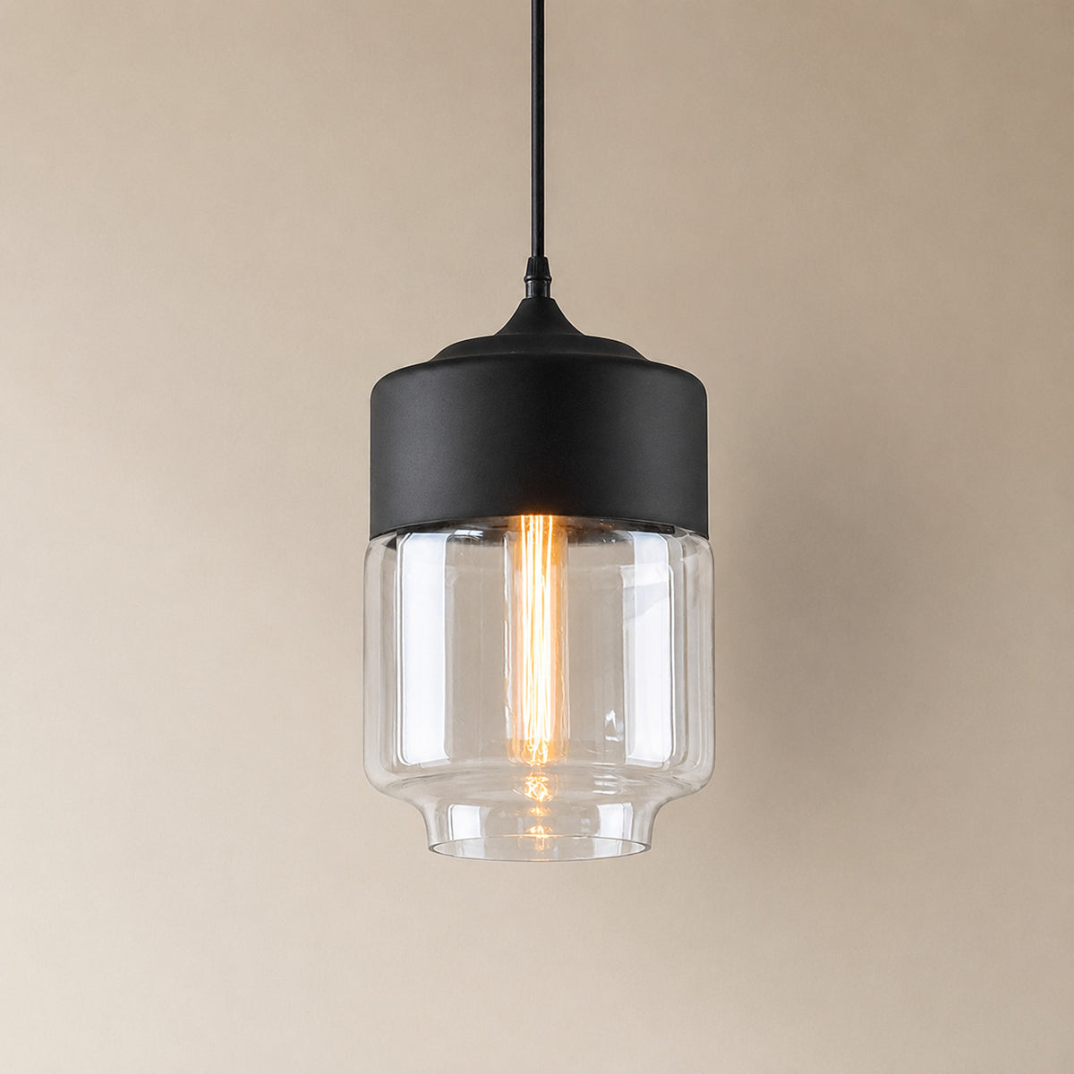 Alge glass pendant with a matte black cap and a clear glass shade, a shorter, wider upright cylinder measuring 28 by 18 cm