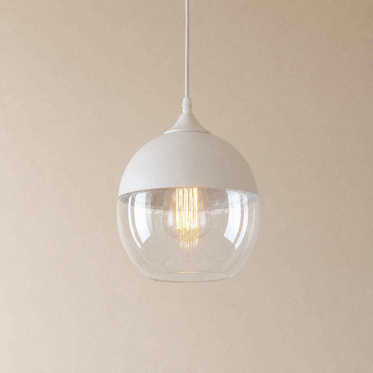Alge glass pendant with a white cap and a clear glass shade, a rounded globe