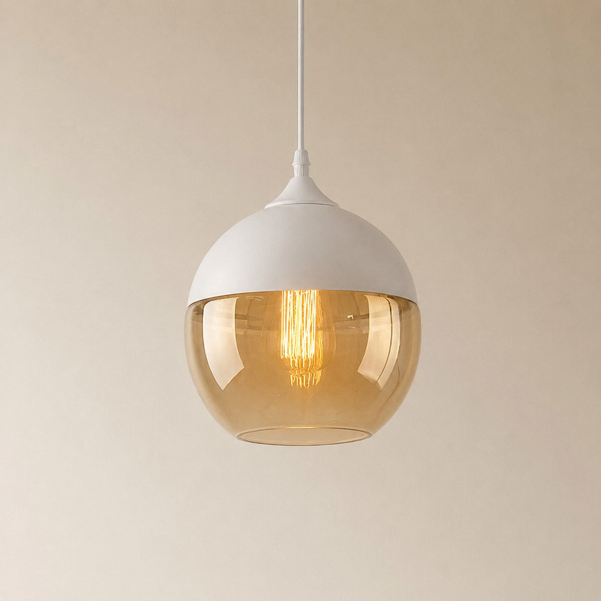 Alge glass pendant with a white cap and an amber glass shade, a rounded globe