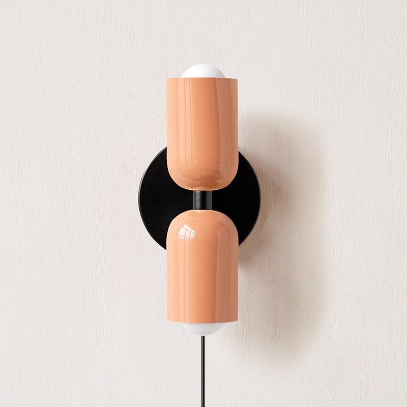 Alvor wall sconce in pink painted metal, both up and down shades shown from the front