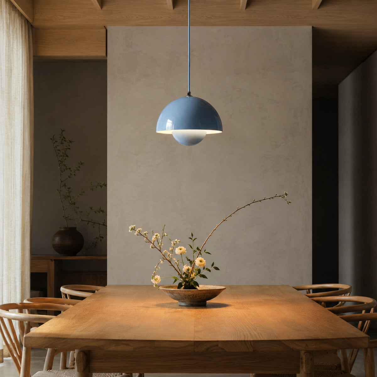 Ave hemisphere pendant in blue on a matching fabric cord, 16 cm tall, shown in a room