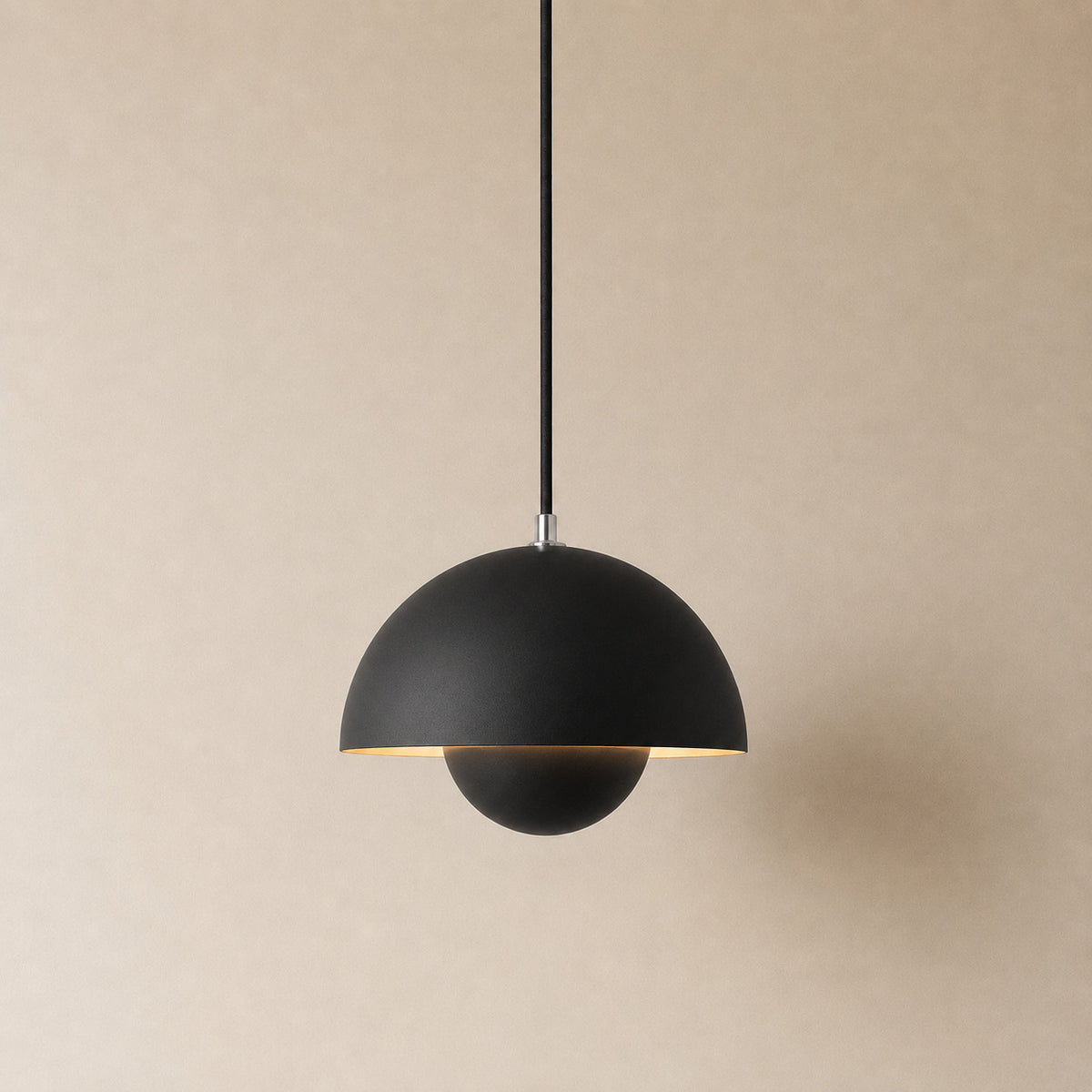 Ave hemisphere pendant in matte black on a matching fabric cord, 16 cm tall