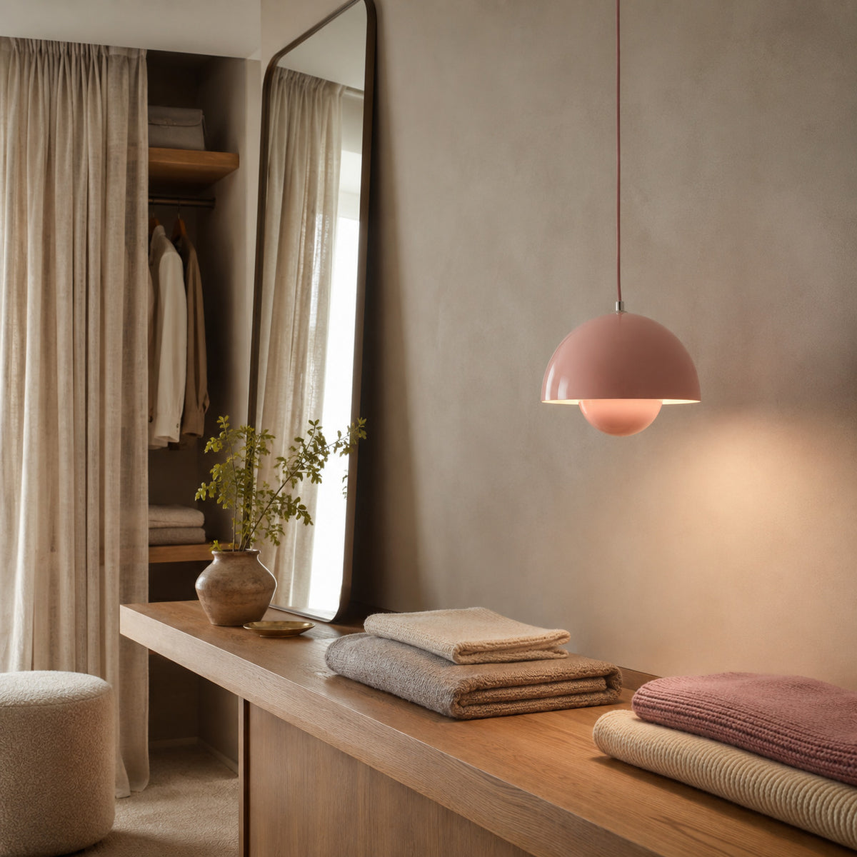 Ave hemisphere pendant in pink on a matching rose-pink fabric cord, 16 cm tall, shown in a room