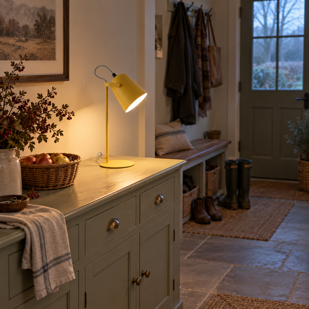 Aveiro iron bucket table lamp in yellow, beside a console table.