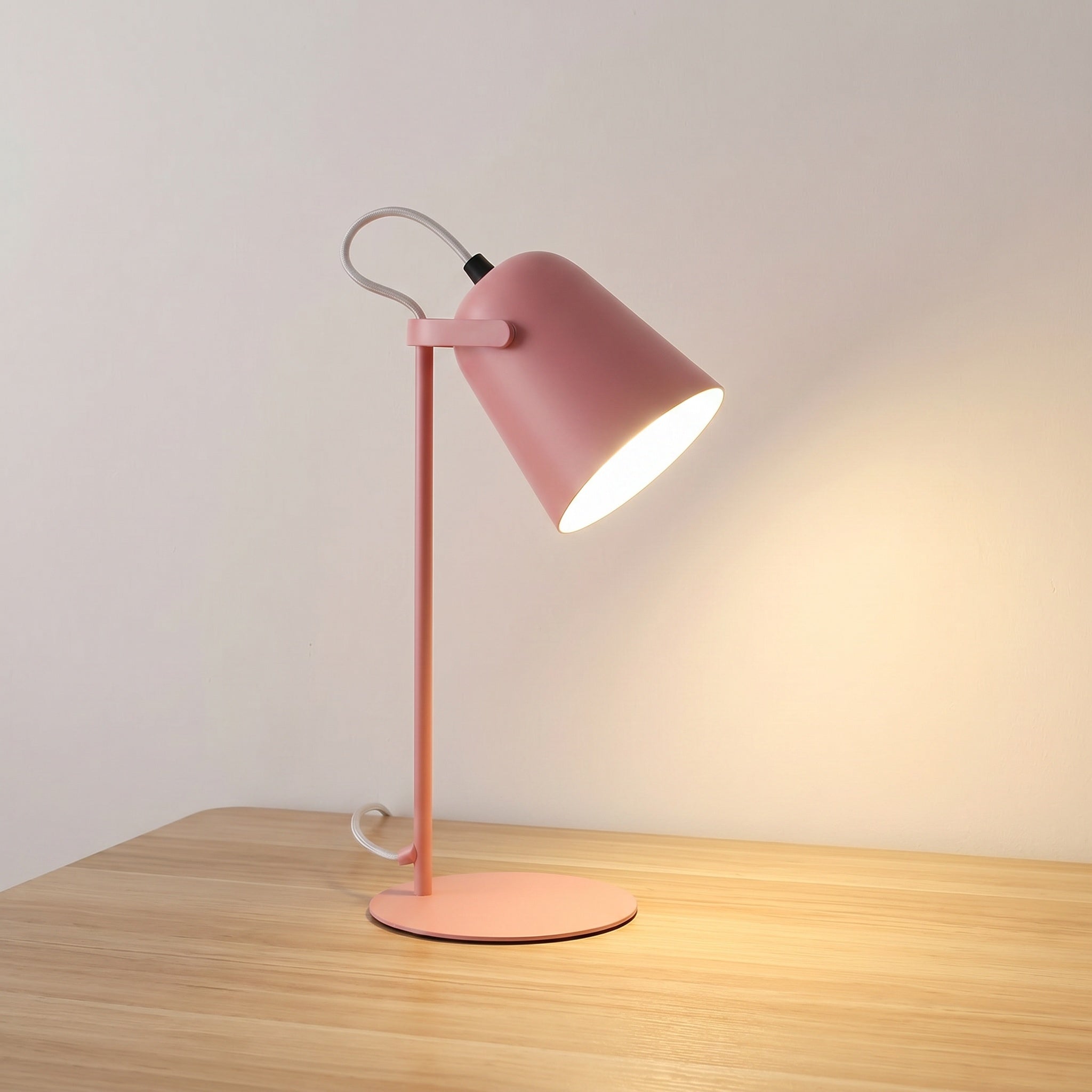 Iron bucket table lamp in macaron pink with tilting shade head, product shot.