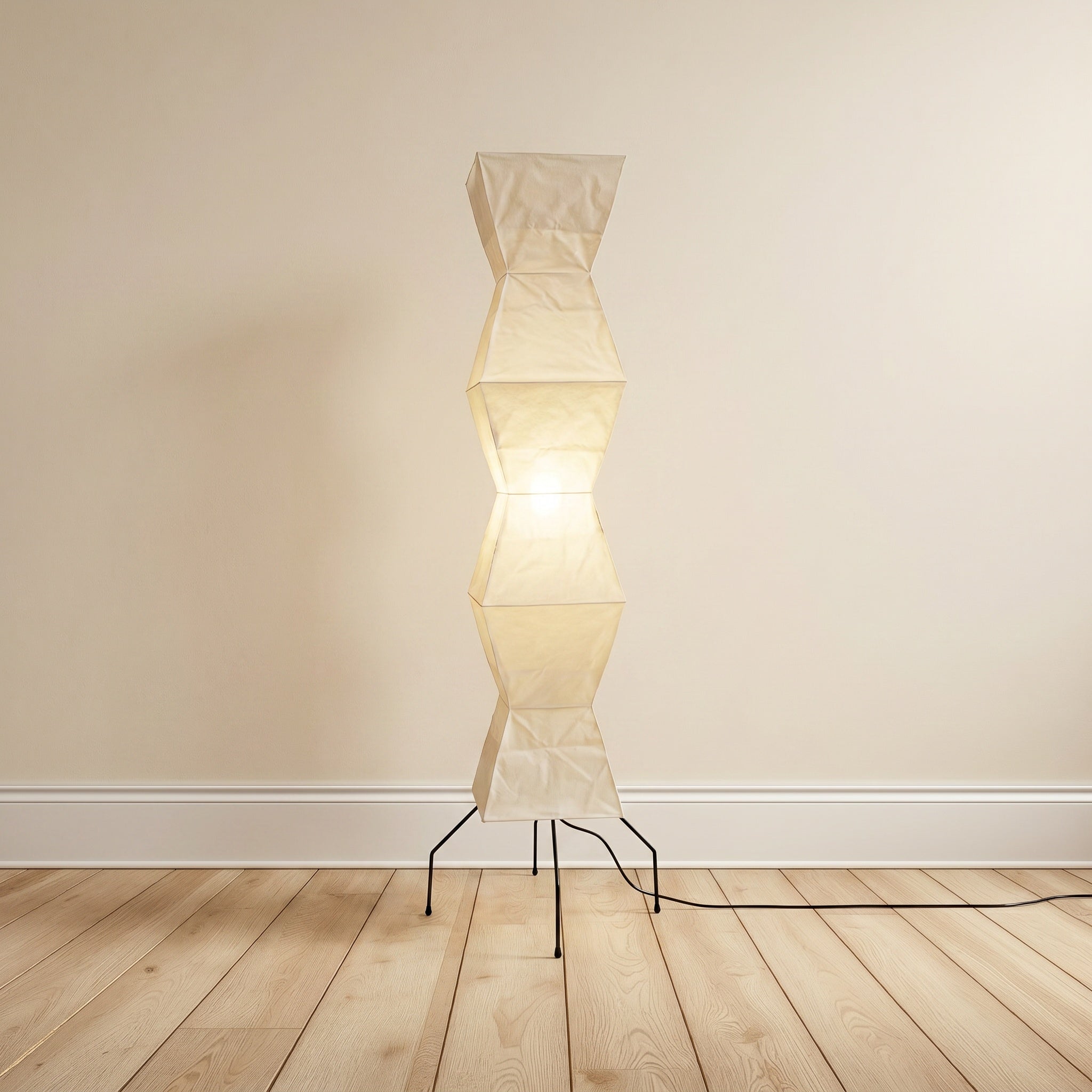 Mulberry-paper floor lamp, faceted geometric shape on a black tripod, product shot.