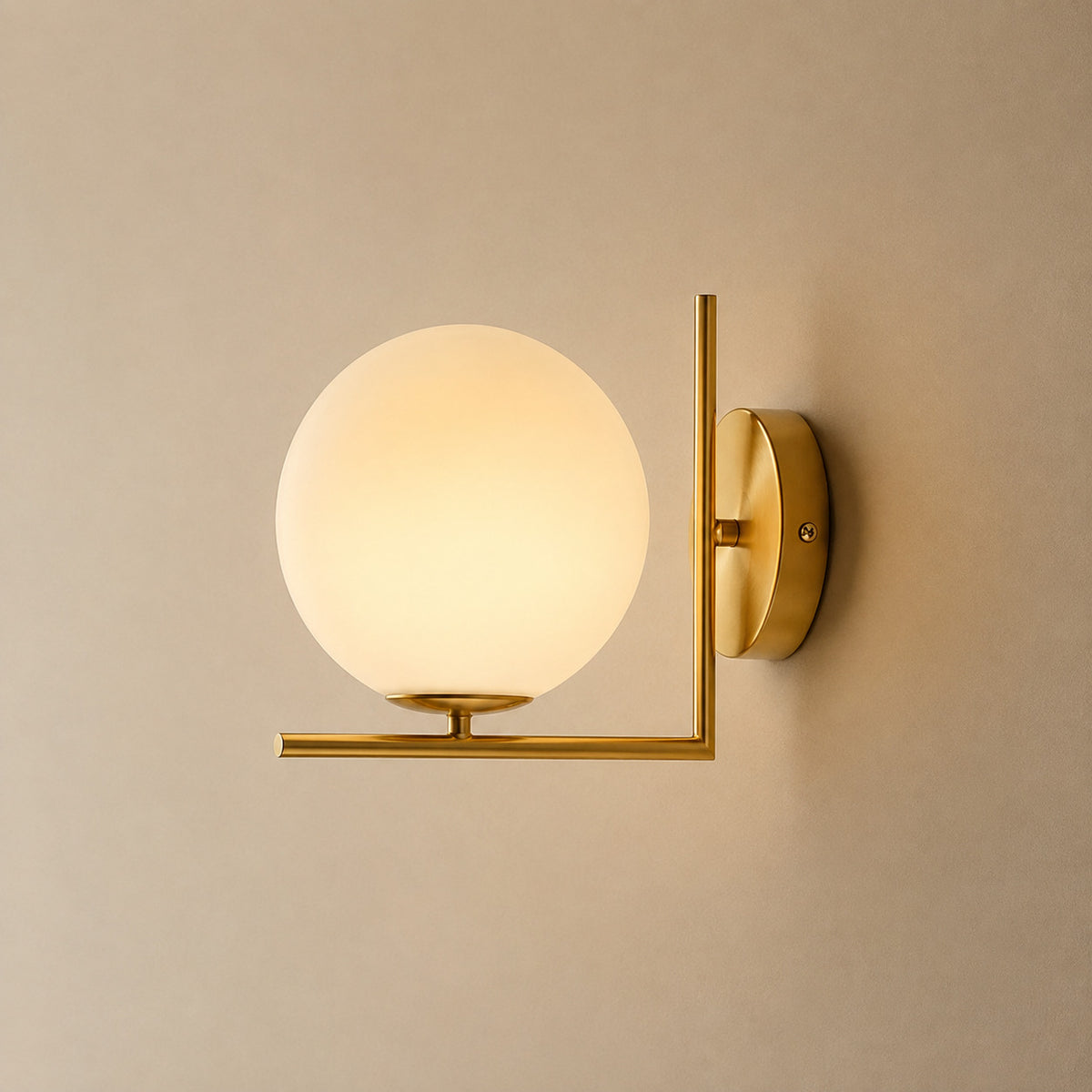 Ceira globe wall sconce with a brass right-angle bracket and an opal white globe