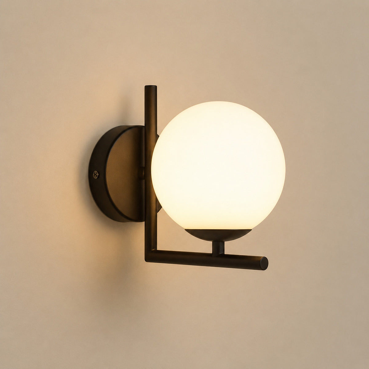 Ceira globe wall sconce with a matte black right-angle bracket and an opal white globe
