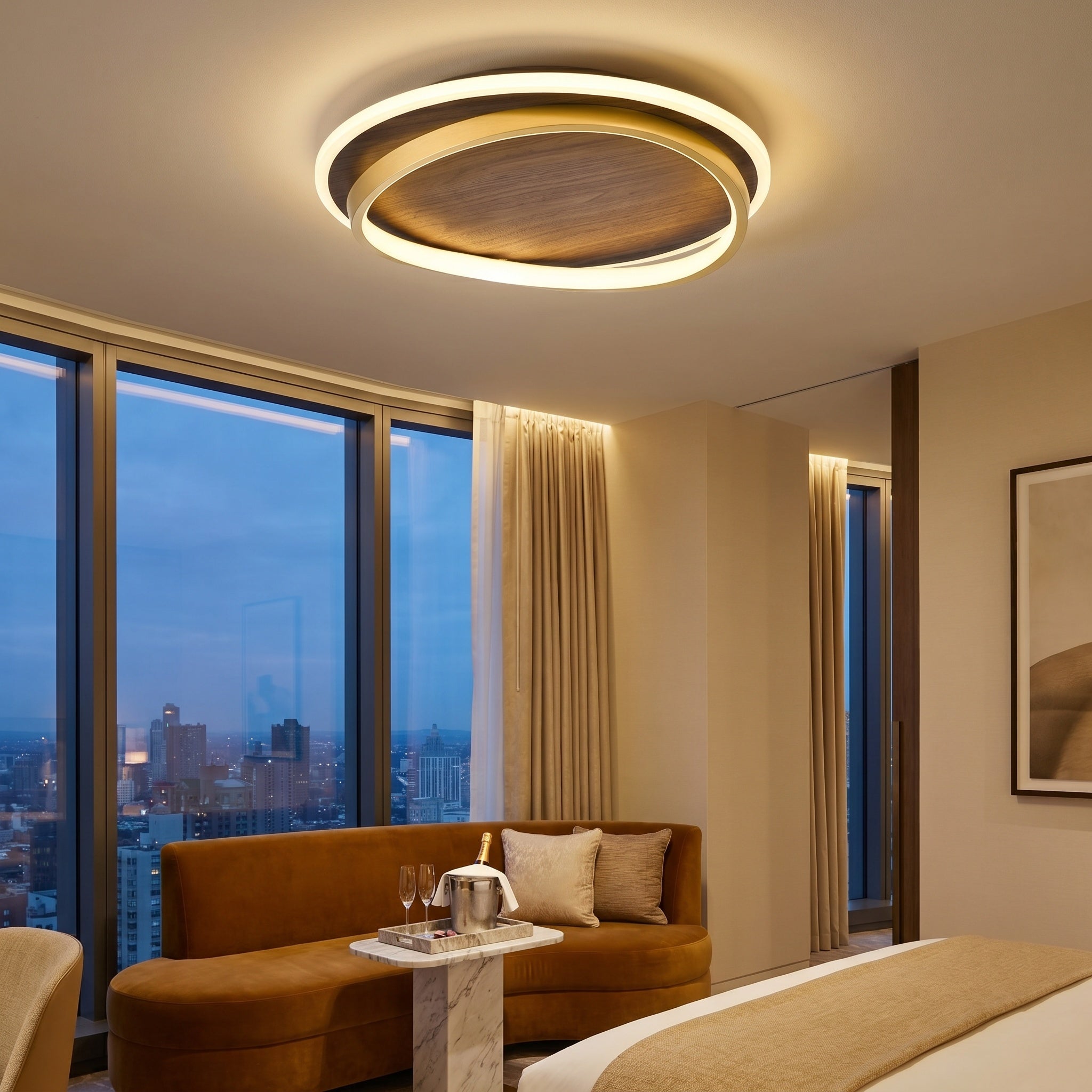 Chaves LED flush mount ceiling light, walnut finish, lit warm above a bedroom with city views at dusk.