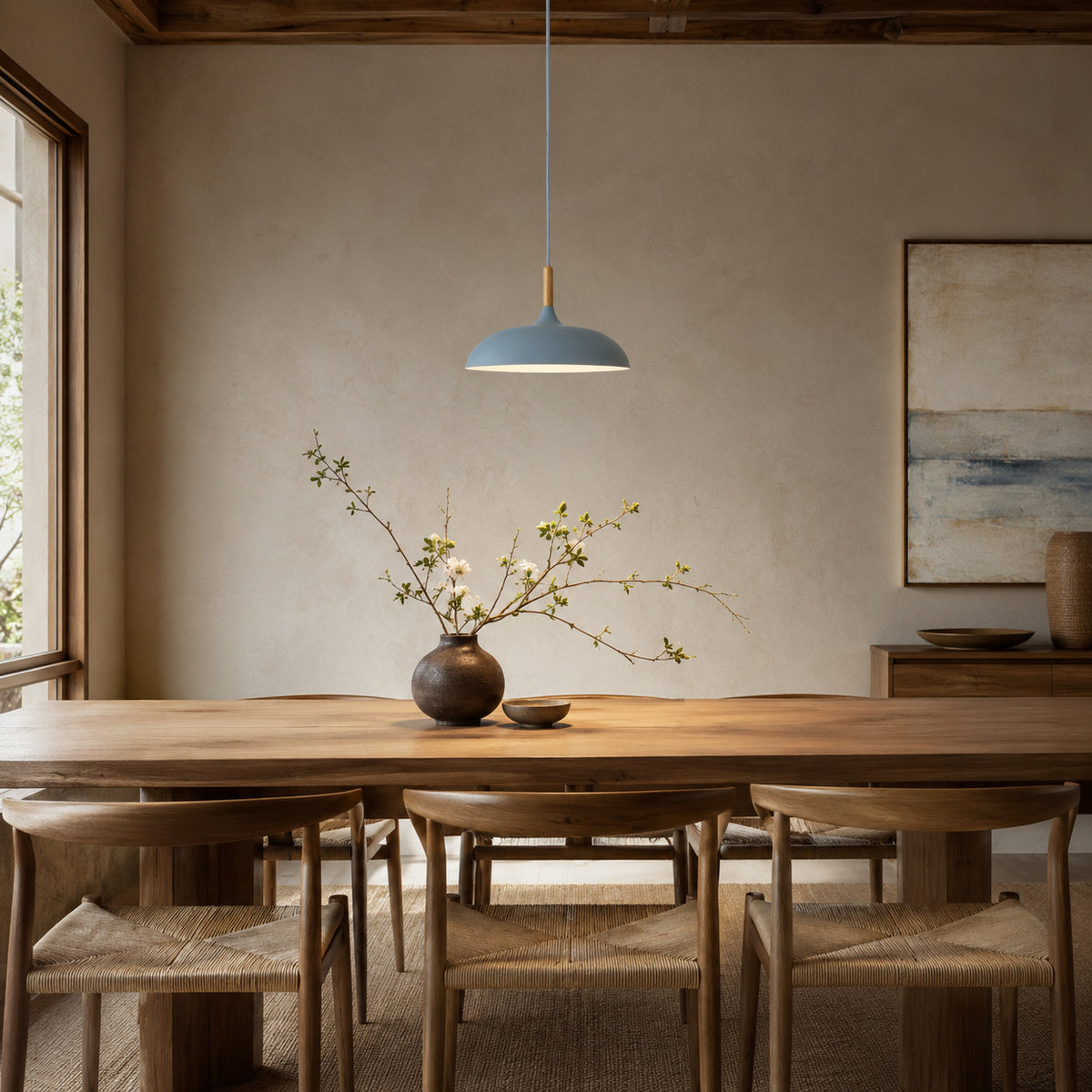 Cobres pendant in muted dusty blue with a turned wood cap, the wide shallow Flat Sphere shade, shown in a room
