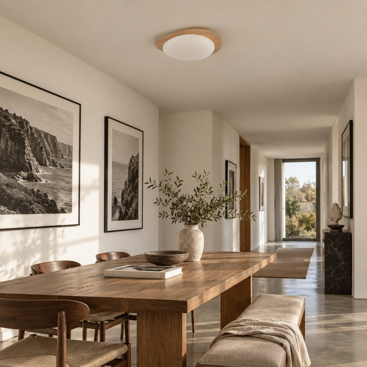 Ericeira pebble form flush mount ceiling light in natural wood grain, in a hallway.