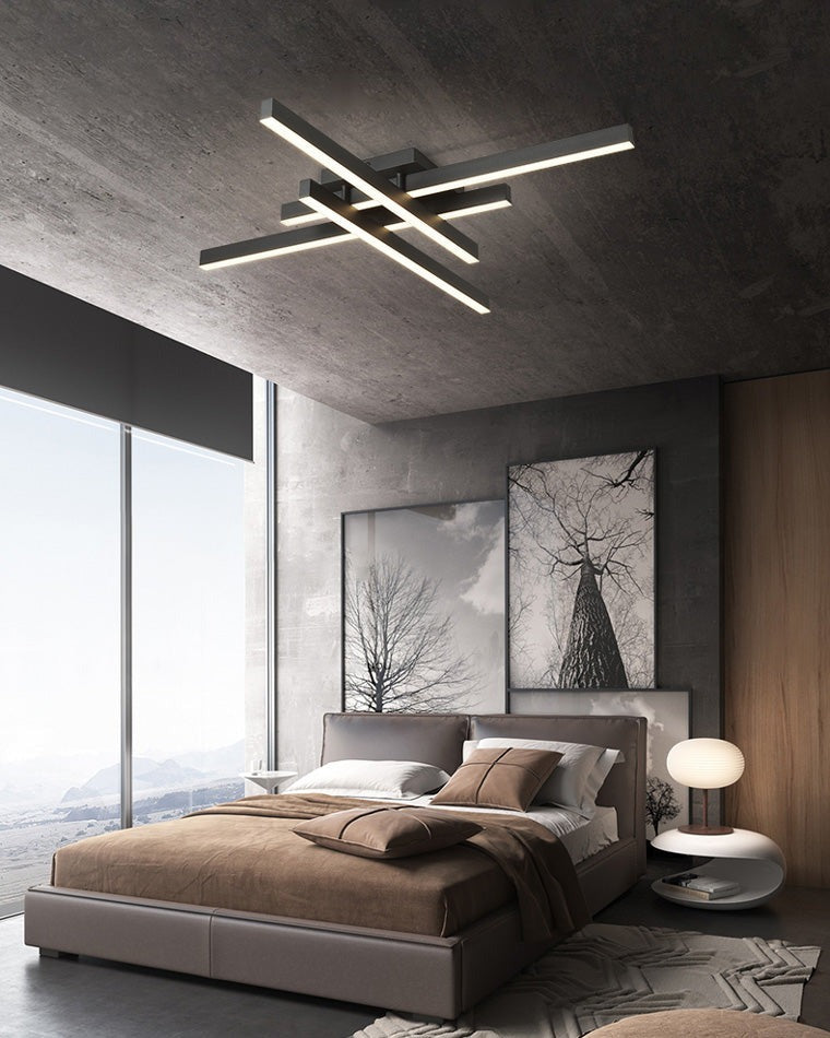 Esposende linear flush mount ceiling light, in a bedroom, beside a dark window wall.