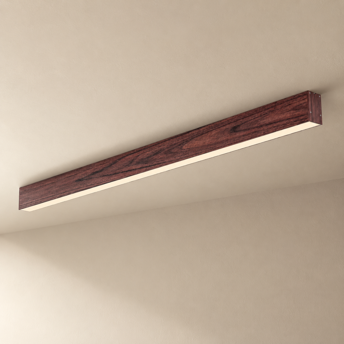 Estarreja linear ceiling light in walnut, on a plain ceiling.