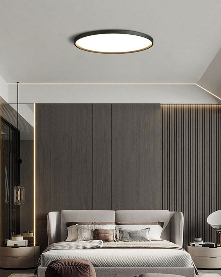Estorãos flat round flush mount ceiling light, in a bedroom, beside a window.