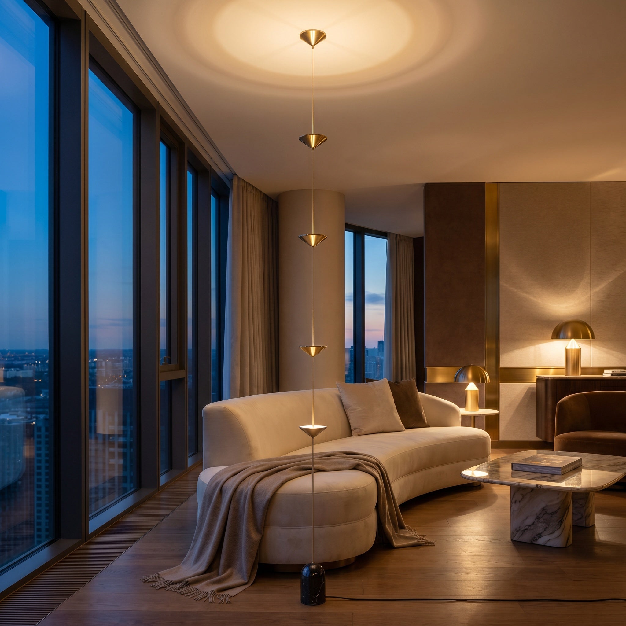 Three-disc gold tension lamp in a penthouse with floor-to-ceiling windows at dusk.