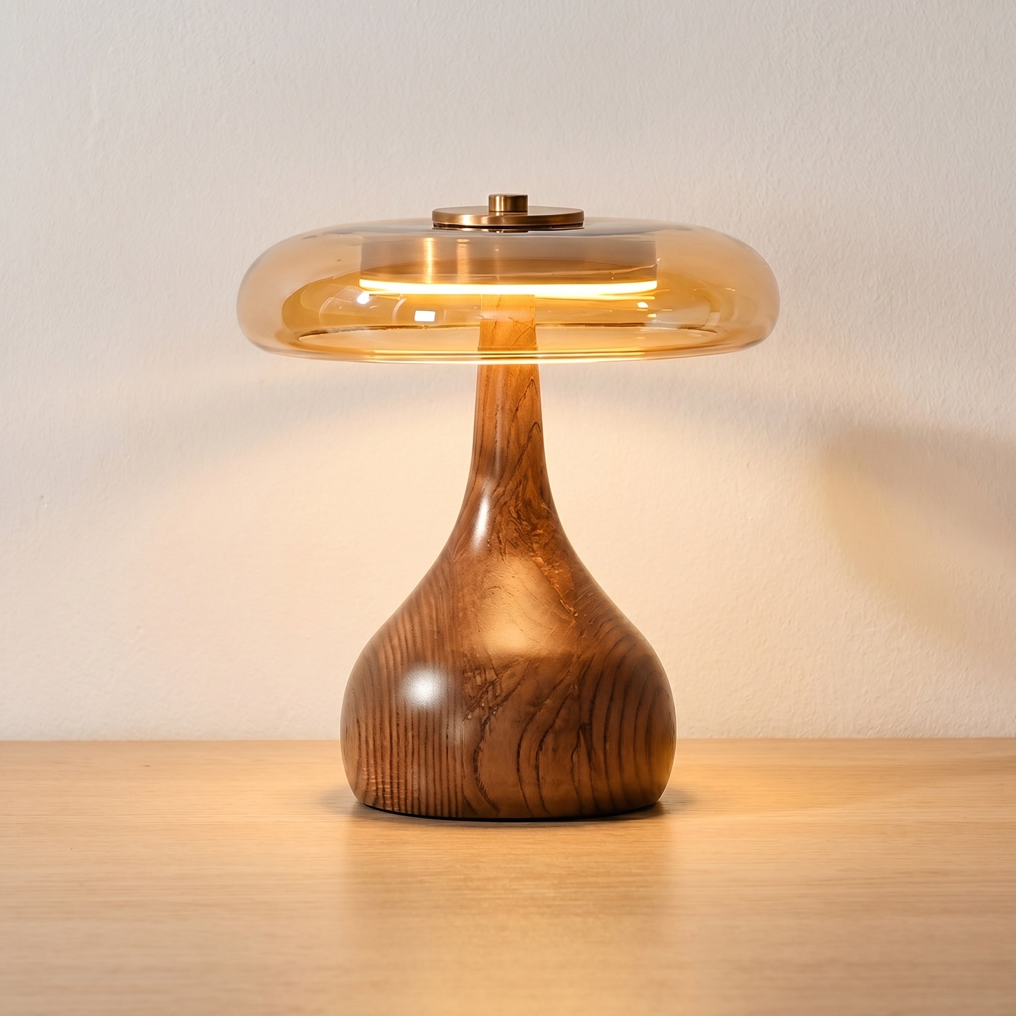 Wooden table lamp with walnut-finished teardrop base and amber glass dome, shorter desk version, product shot.