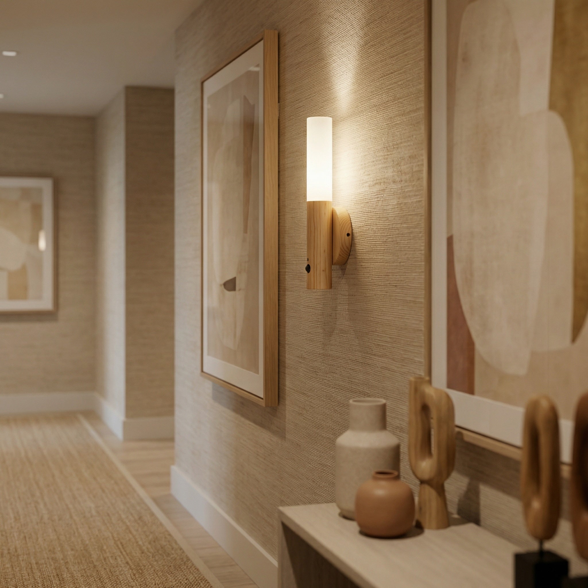 Manteigas sconce mounted beside a hallway wall, casting warm ambient light at night