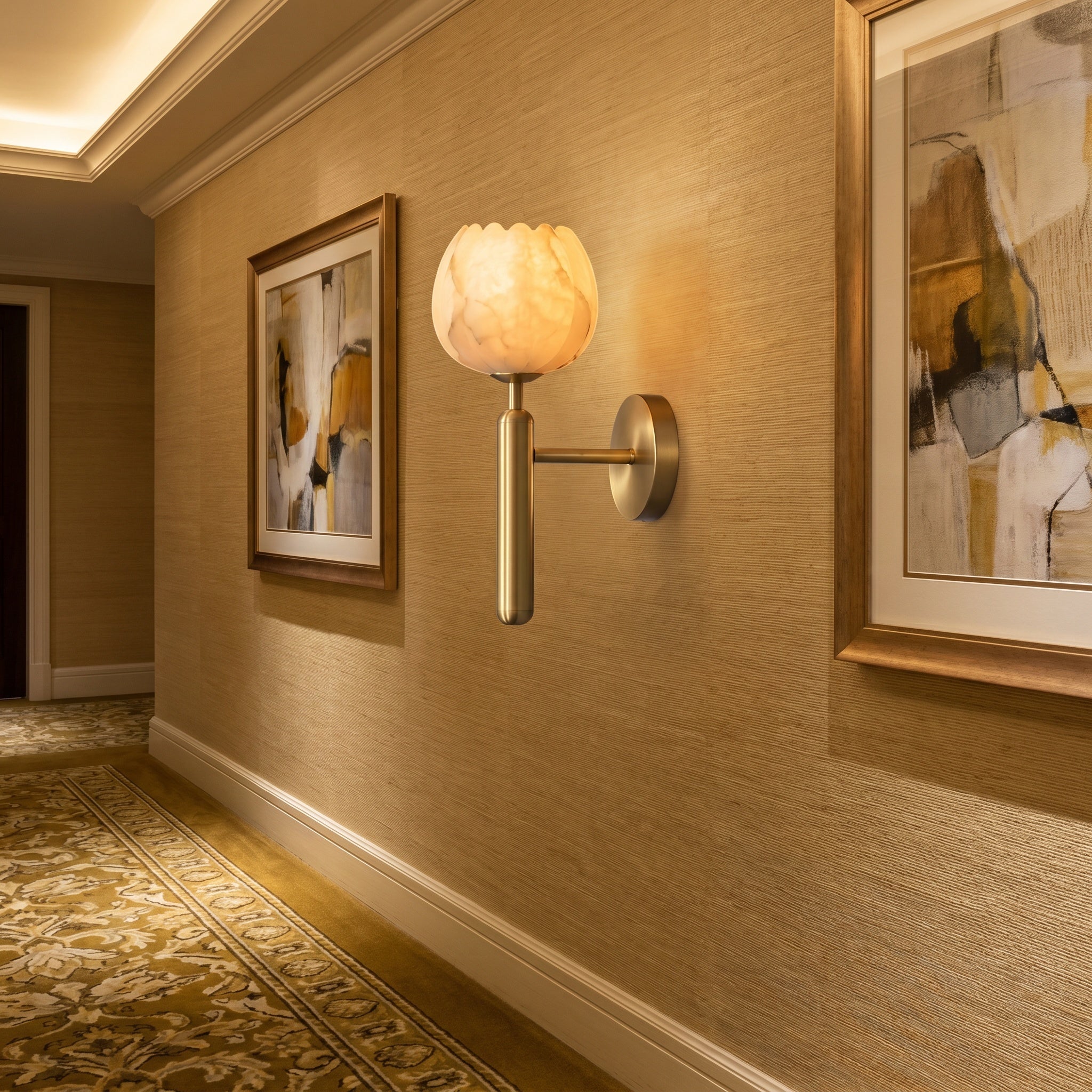 Mértola brass-finish sconce beside a bedroom mirror, petals lit from within at dusk