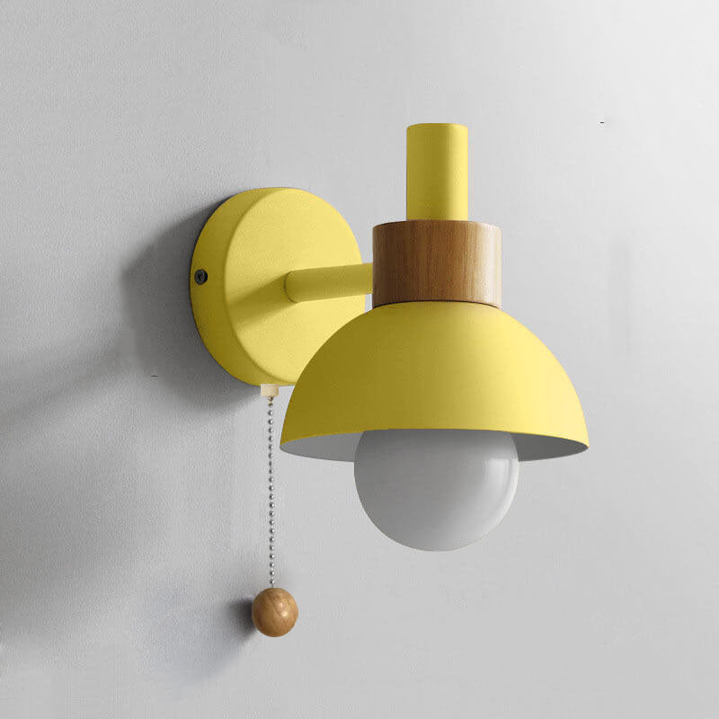 Milfontes macaron wall sconce in lemon yellow, with a wood neck and white glass globe, pull-chain switch