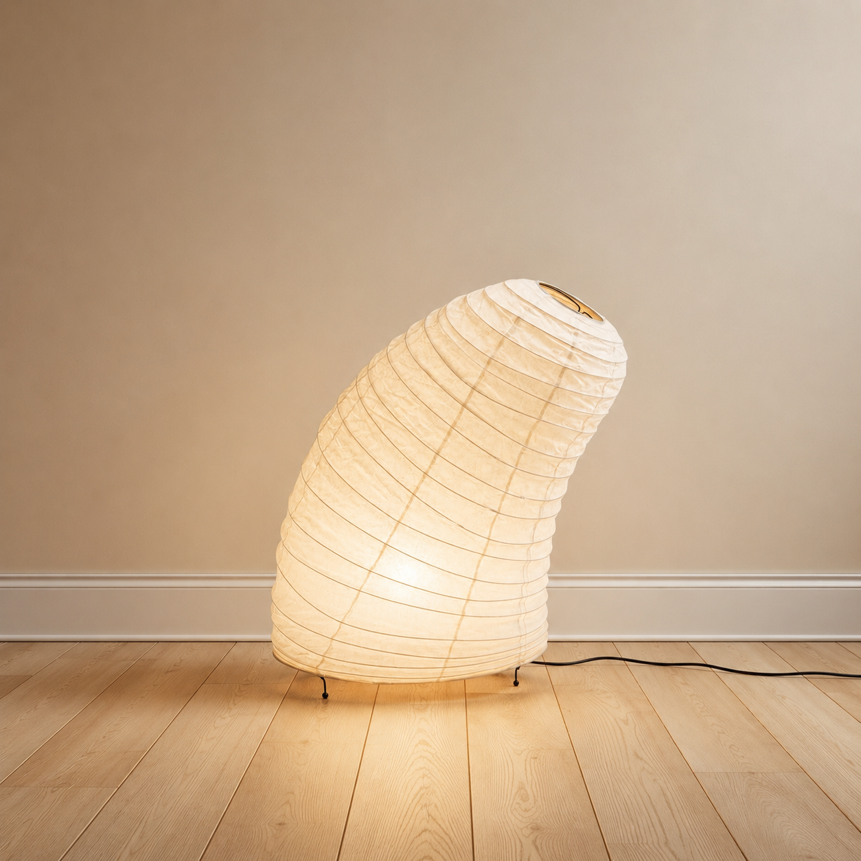 Handmade mulberry paper lamp glowing in a neutral living room.