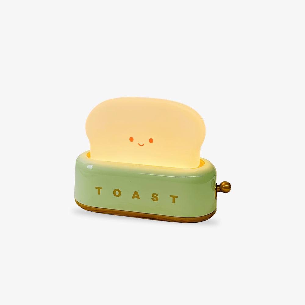 Toaster-shape LED night light glowing on a desk.