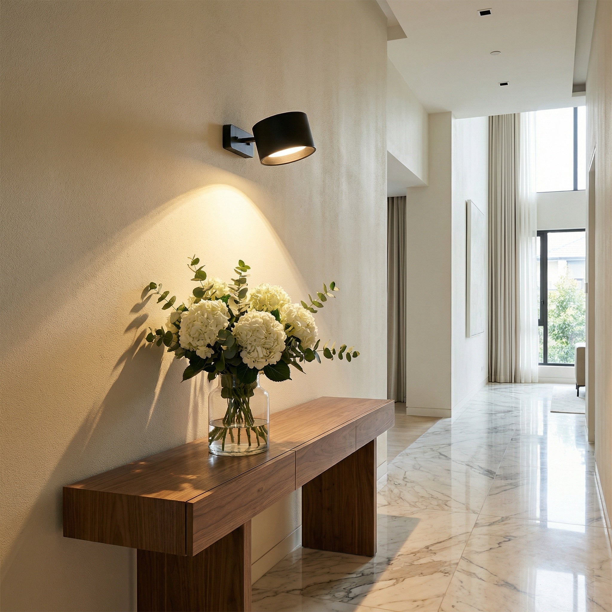 Nisa rechargeable LED wall sconce with head pivoted to cast warm downward light