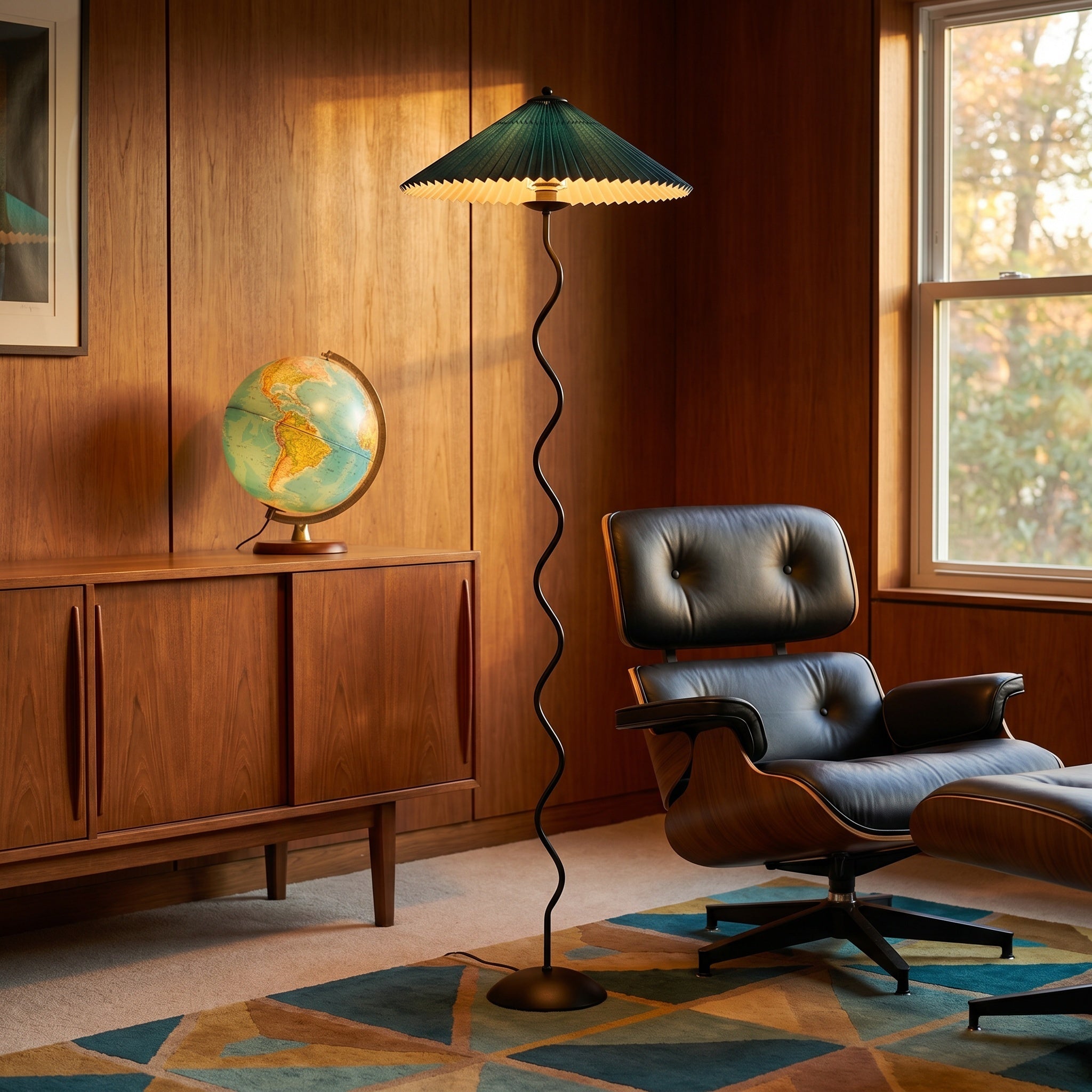 Wavy-stem floor lamp with dark green shade beside an Eames-style chair and a globe.