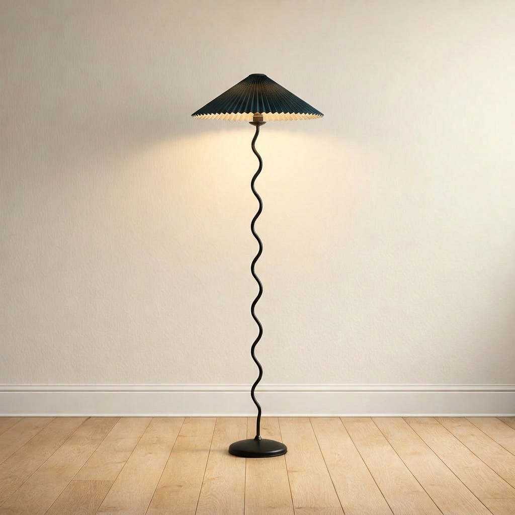 Wavy-stem floor lamp with a dark green pleated fabric shade, plain-wall product shot.
