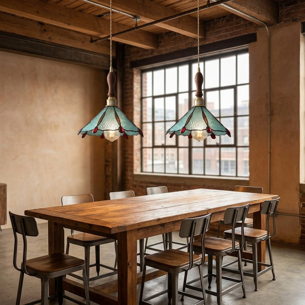 Two Burgau leaded glass pendants in teal over a dining table