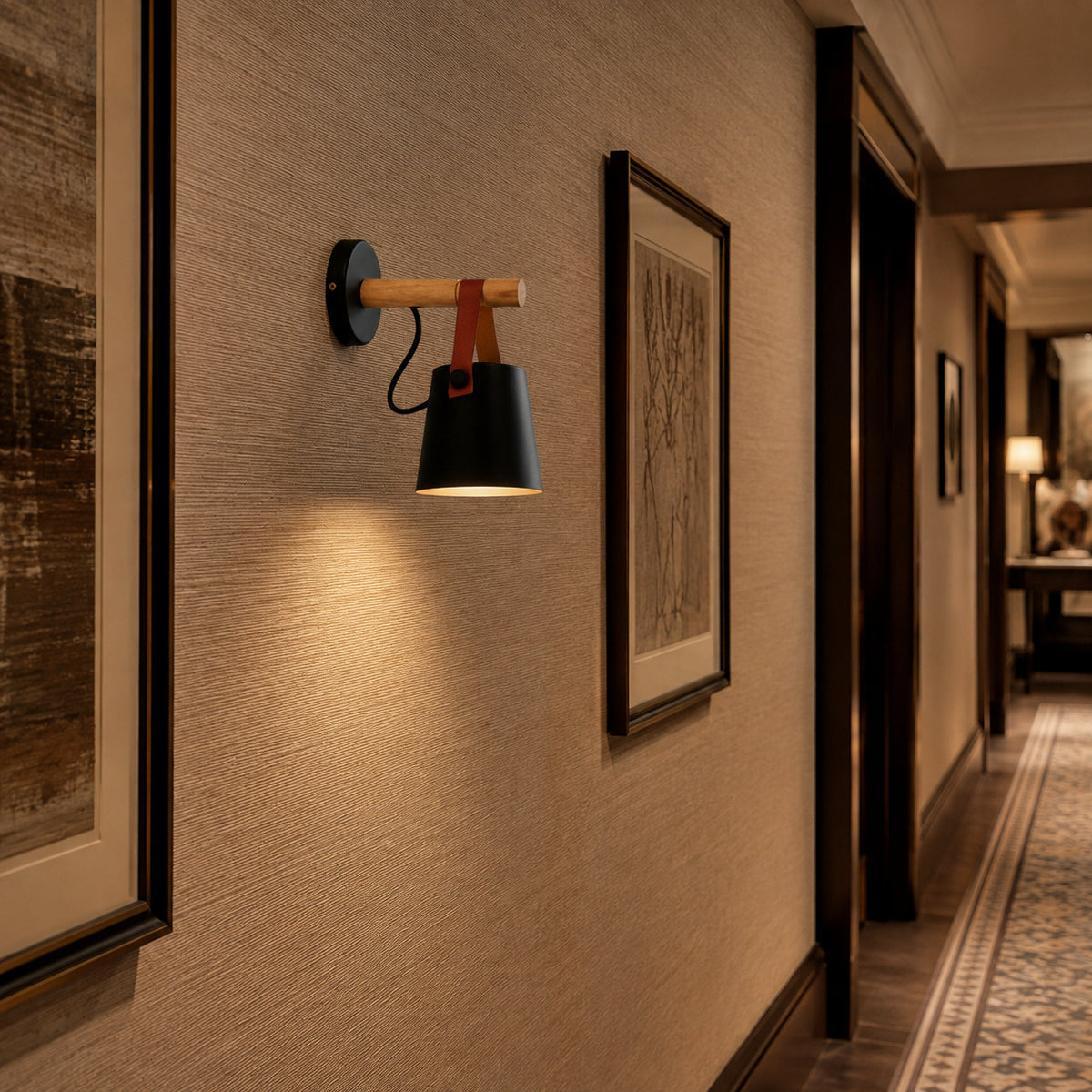 Alfusqueiro sconce in black in a hotel corridor beside framed artwork