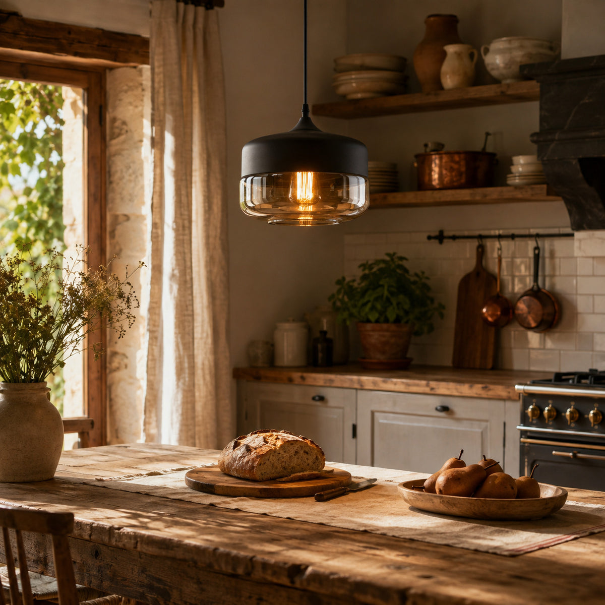 Alge pendant in black and amber, wide drum shape, above a table in a French country kitchen