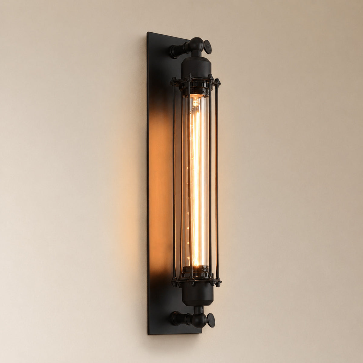 Almonda industrial tube wall sconce in matte black iron with a caged tubular Edison bulb