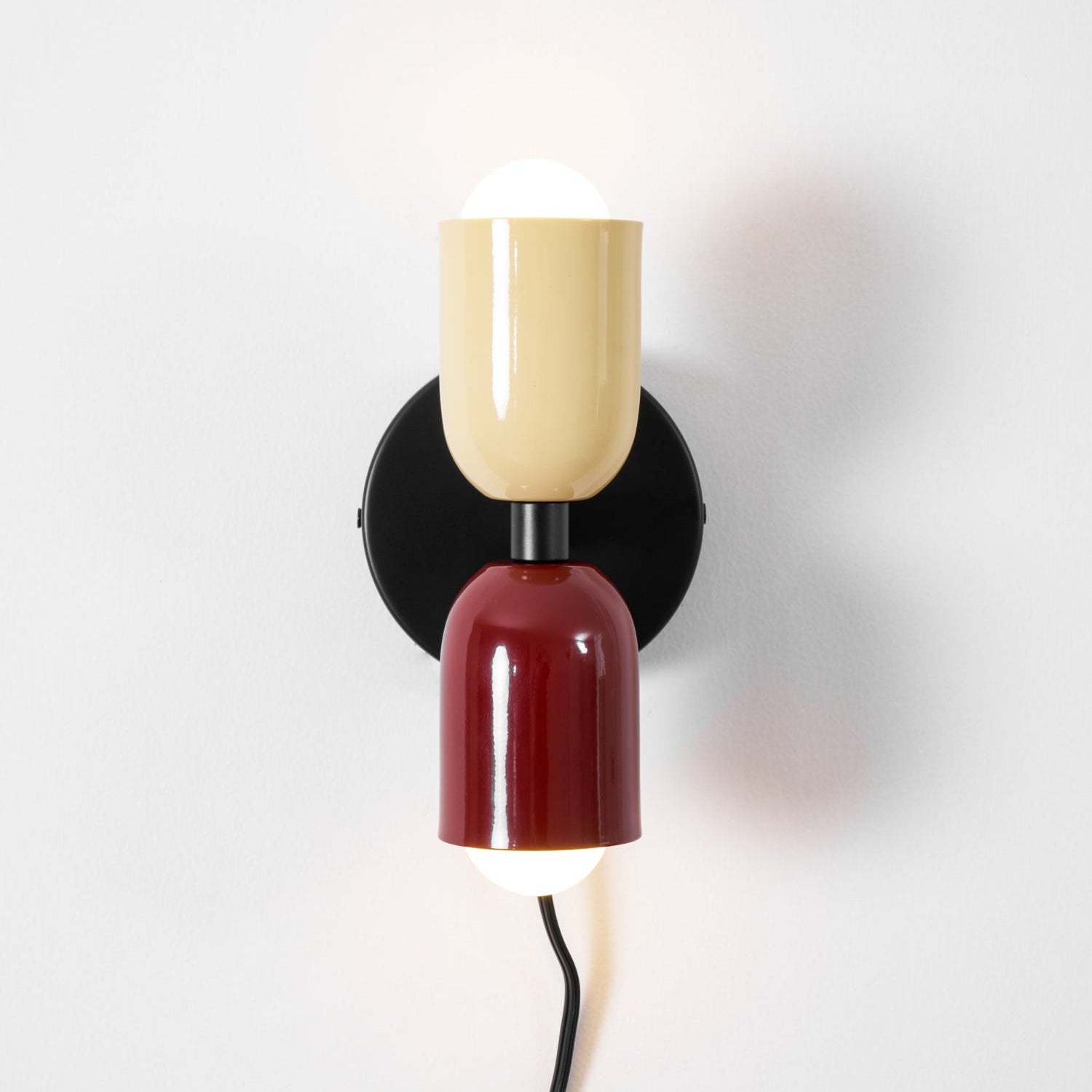 Alvor wall sconce close detail, beige upper and red lower painted metal shades on white