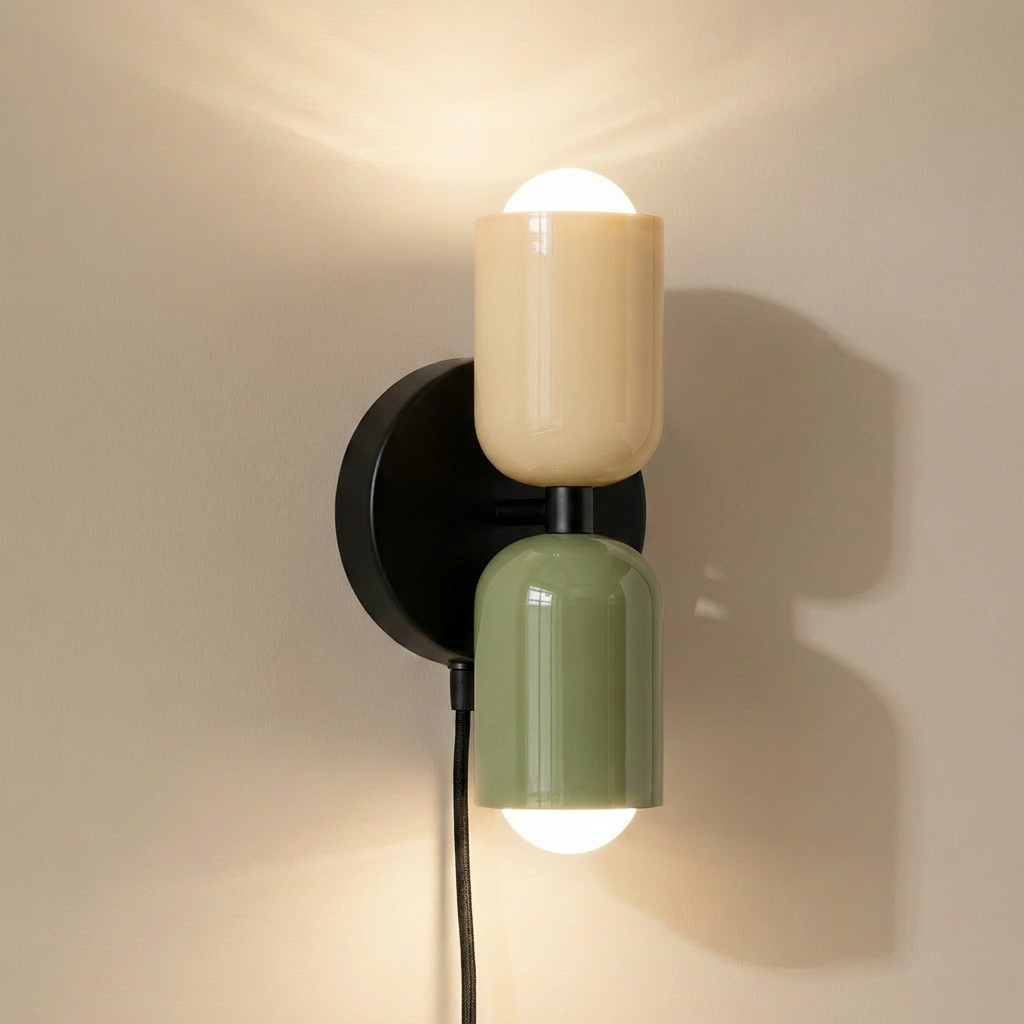 Alvor up-and-down wall sconce lit, beige upper and green lower painted metal shades on black backplate
