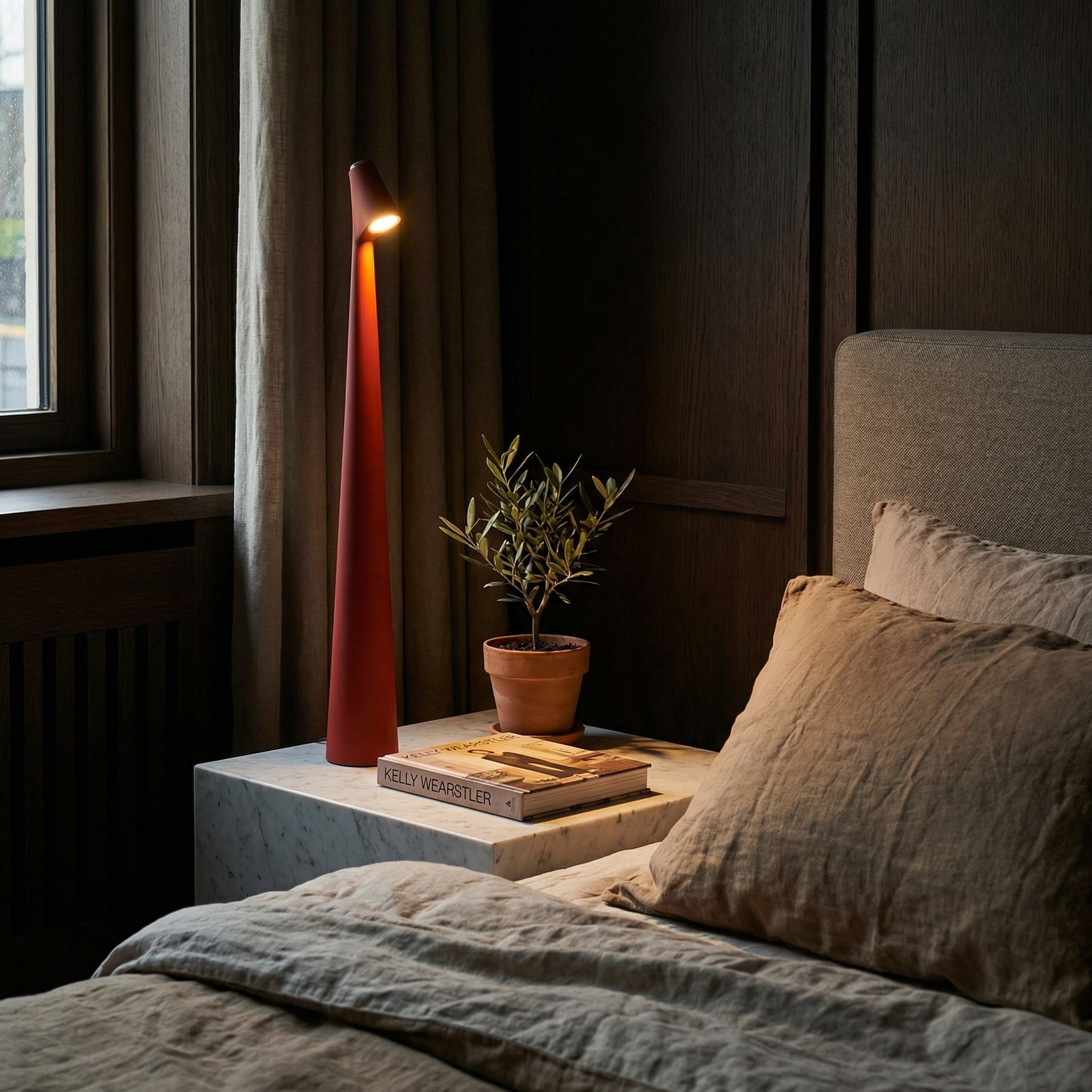 Slim cordless mood lamp on a dining table casting warm ambient light.