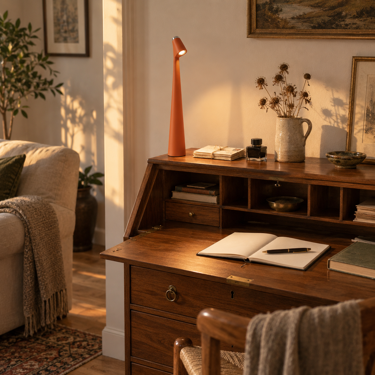 Amarante cordless LED mood lamp in orange, in a living room.