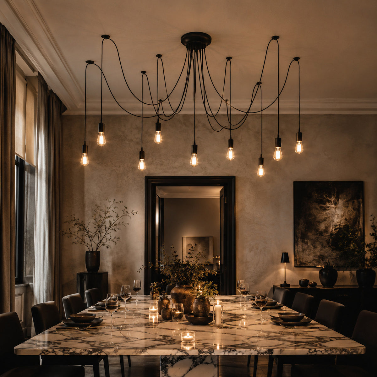 Anadia spider chandelier above a marble dining table set for dinner