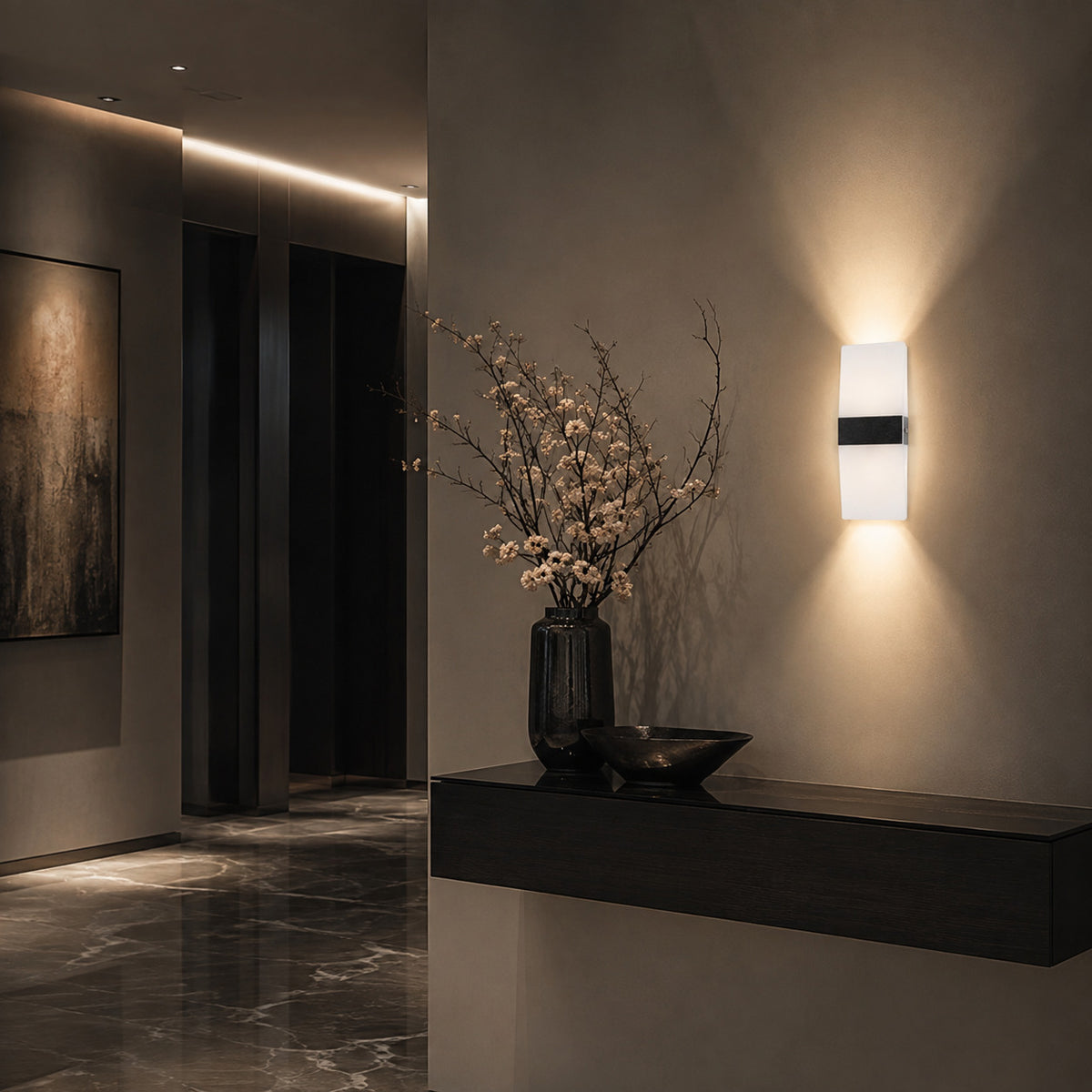 Anços sconce in black with warm white light as a wall accent in a Scandinavian living room