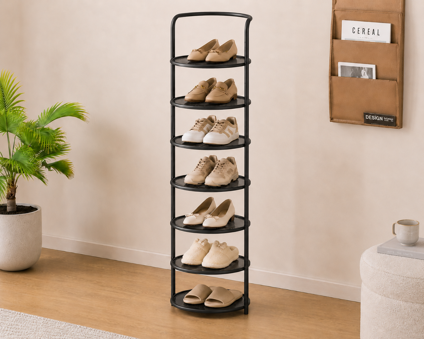Black 8-tier Arribada shoe storage rack beside palm plant and wall-mounted magazine holder