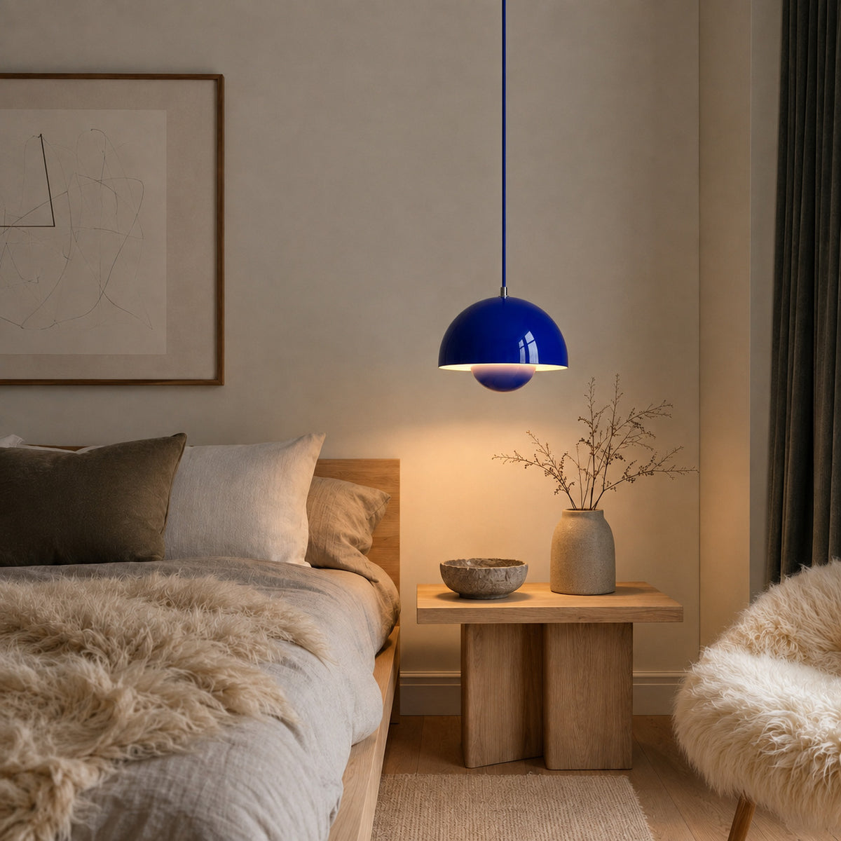 Ave hemisphere pendant in klein blue on a matching fabric cord, 16 cm tall, shown in a room