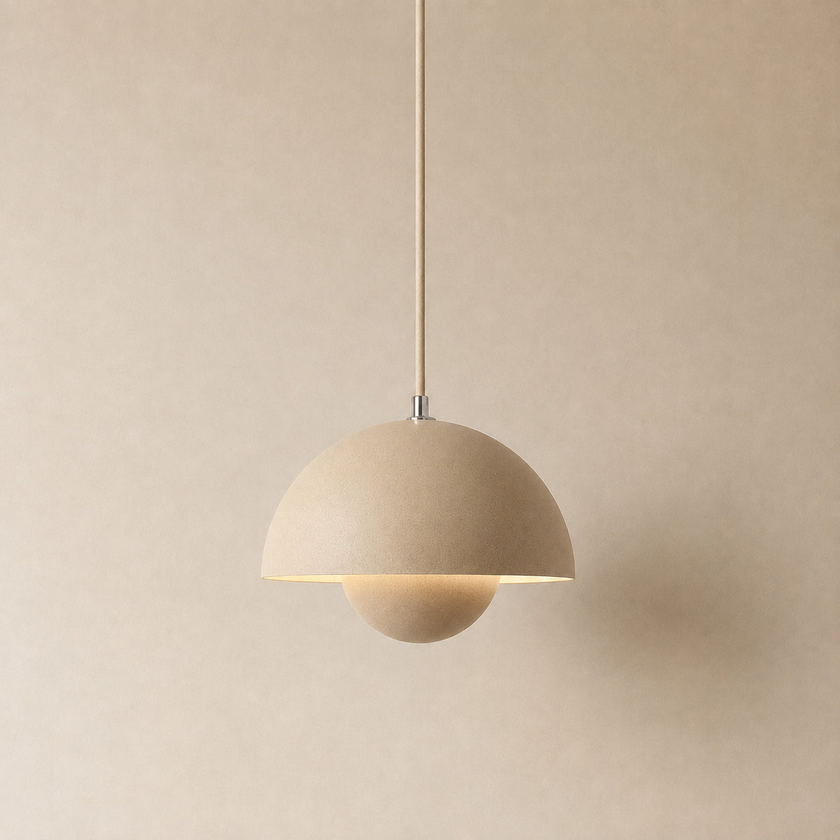 Ave hemisphere pendant in matte beige on a matching fabric cord, 16 cm tall