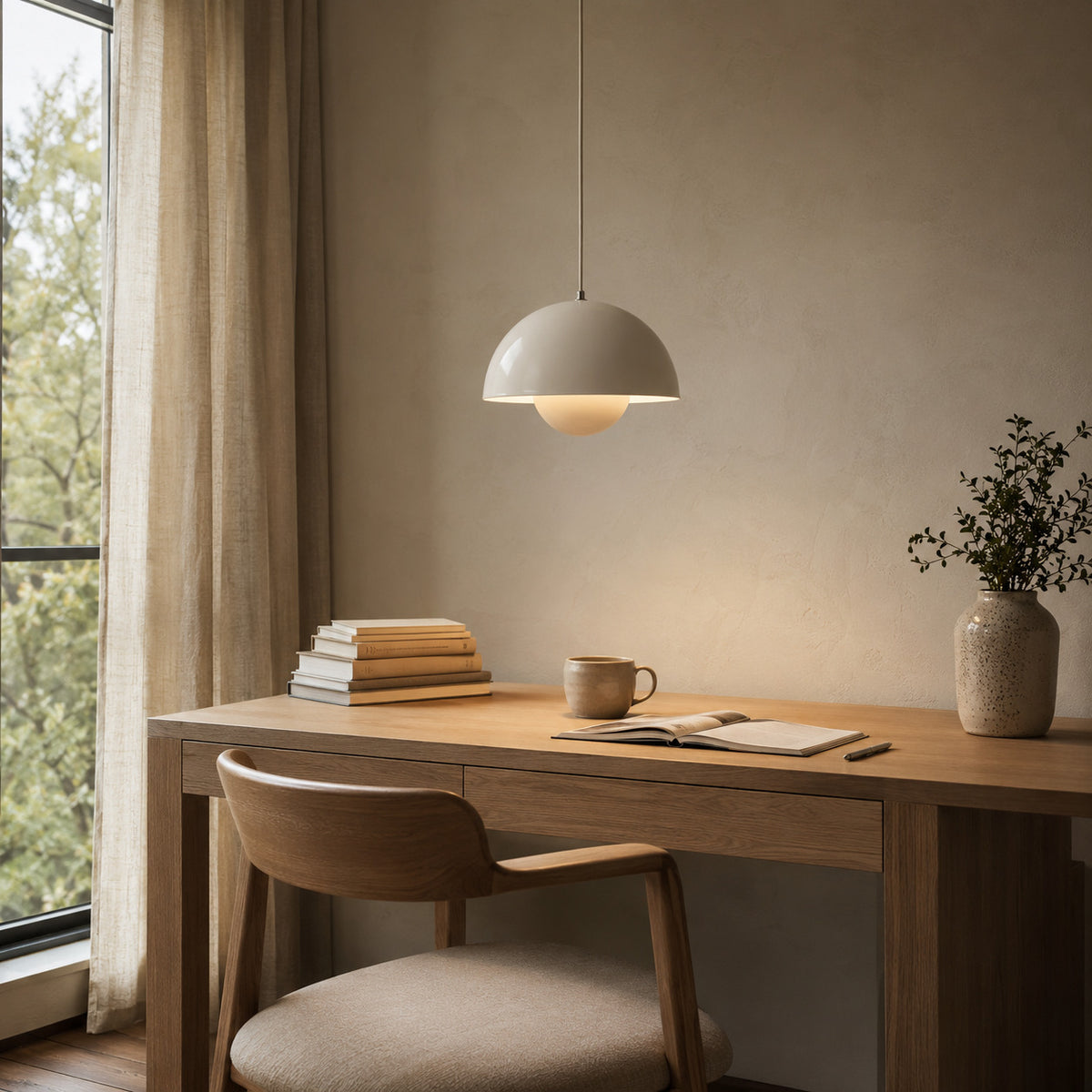 Ave hemisphere pendant in matte beige on a matching fabric cord, 16 cm tall, shown in a room