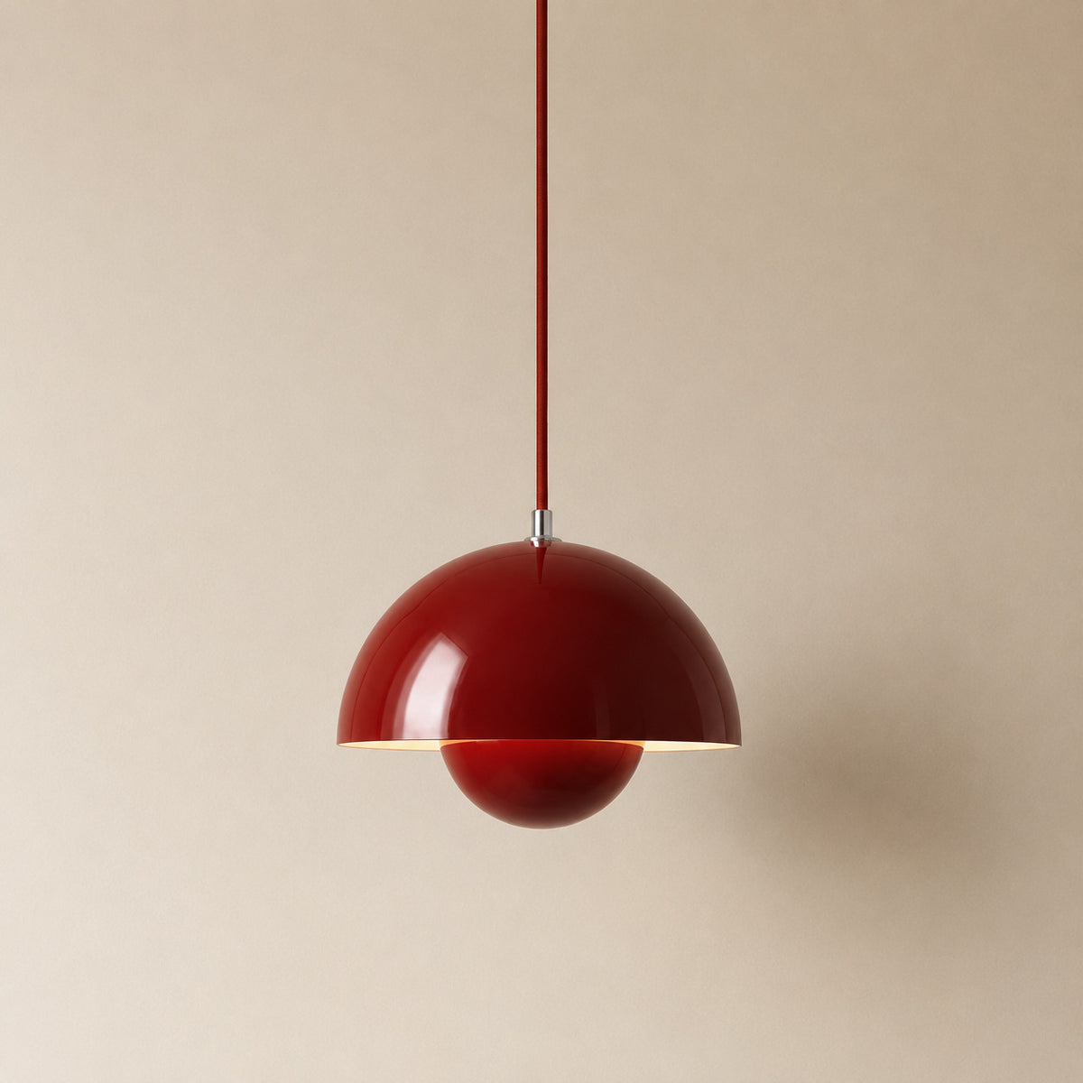 Ave hemisphere pendant in red on a matching fabric cord, 16 cm tall
