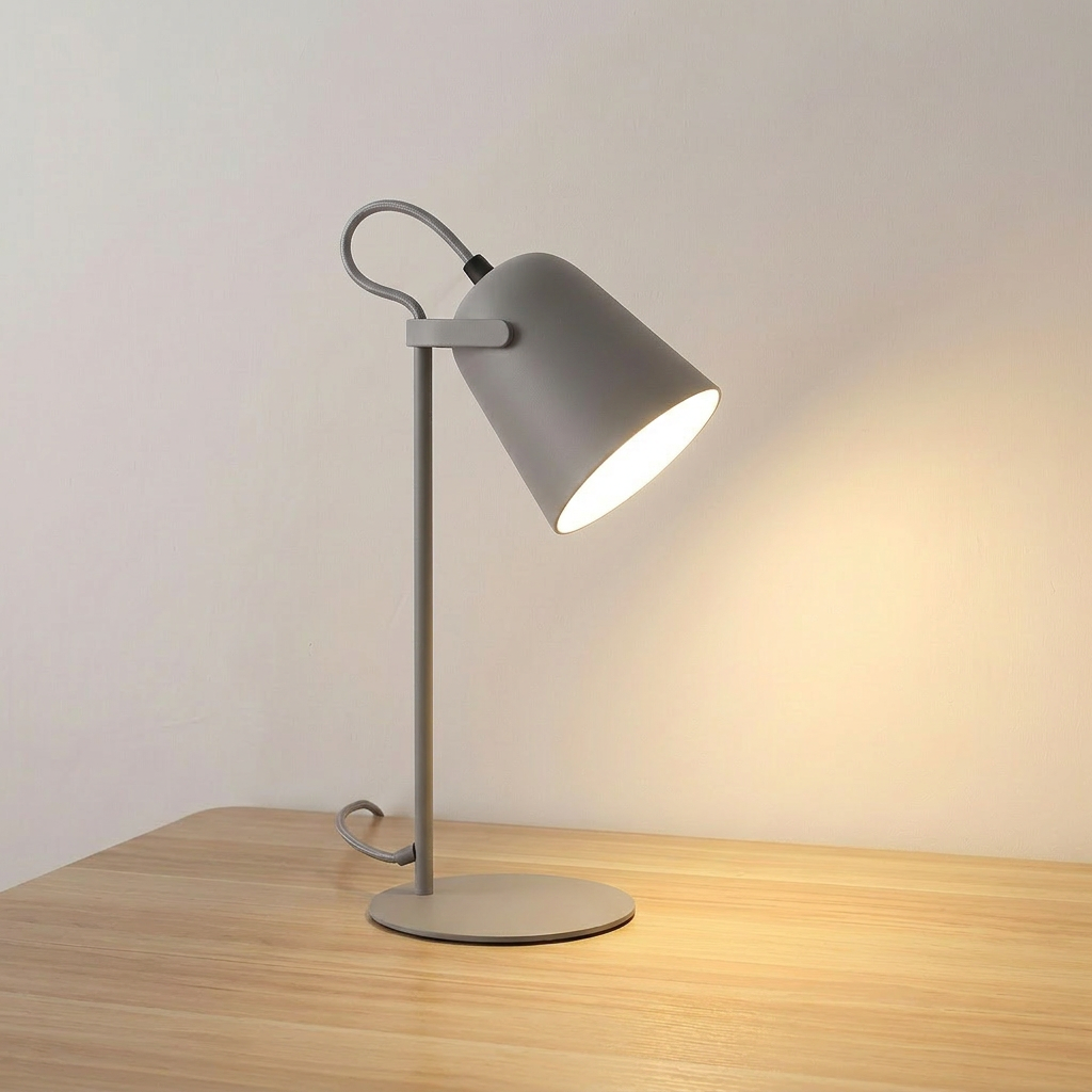 Iron bucket table lamp in black with tilting shade head, product shot.