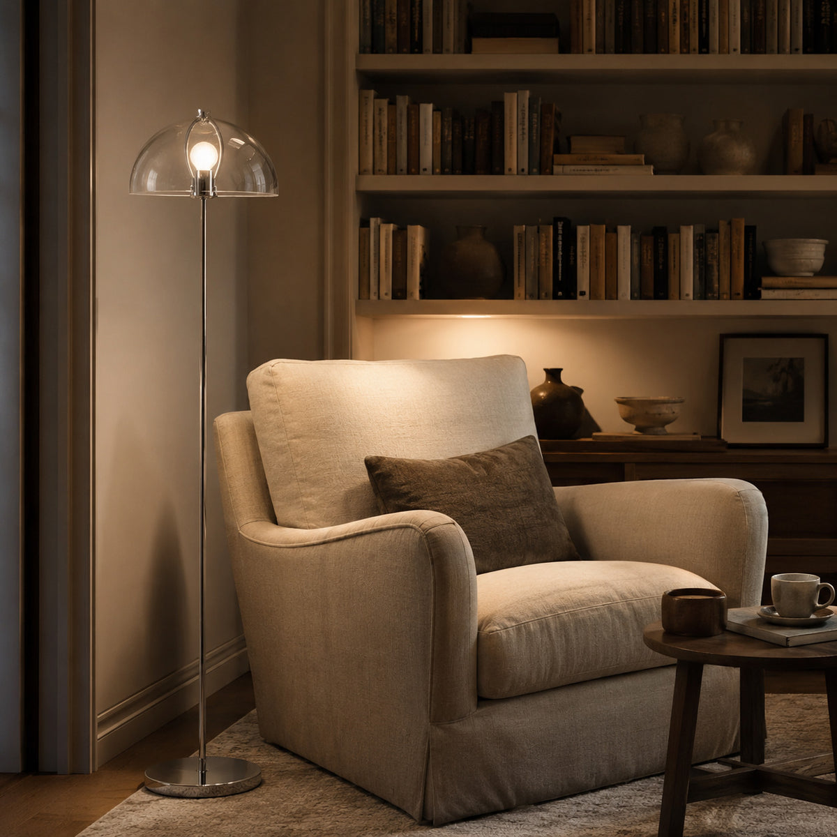 Benavente floor lamp with a clear acrylic dome shade and chrome stem, 155 cm tall, shown in a room