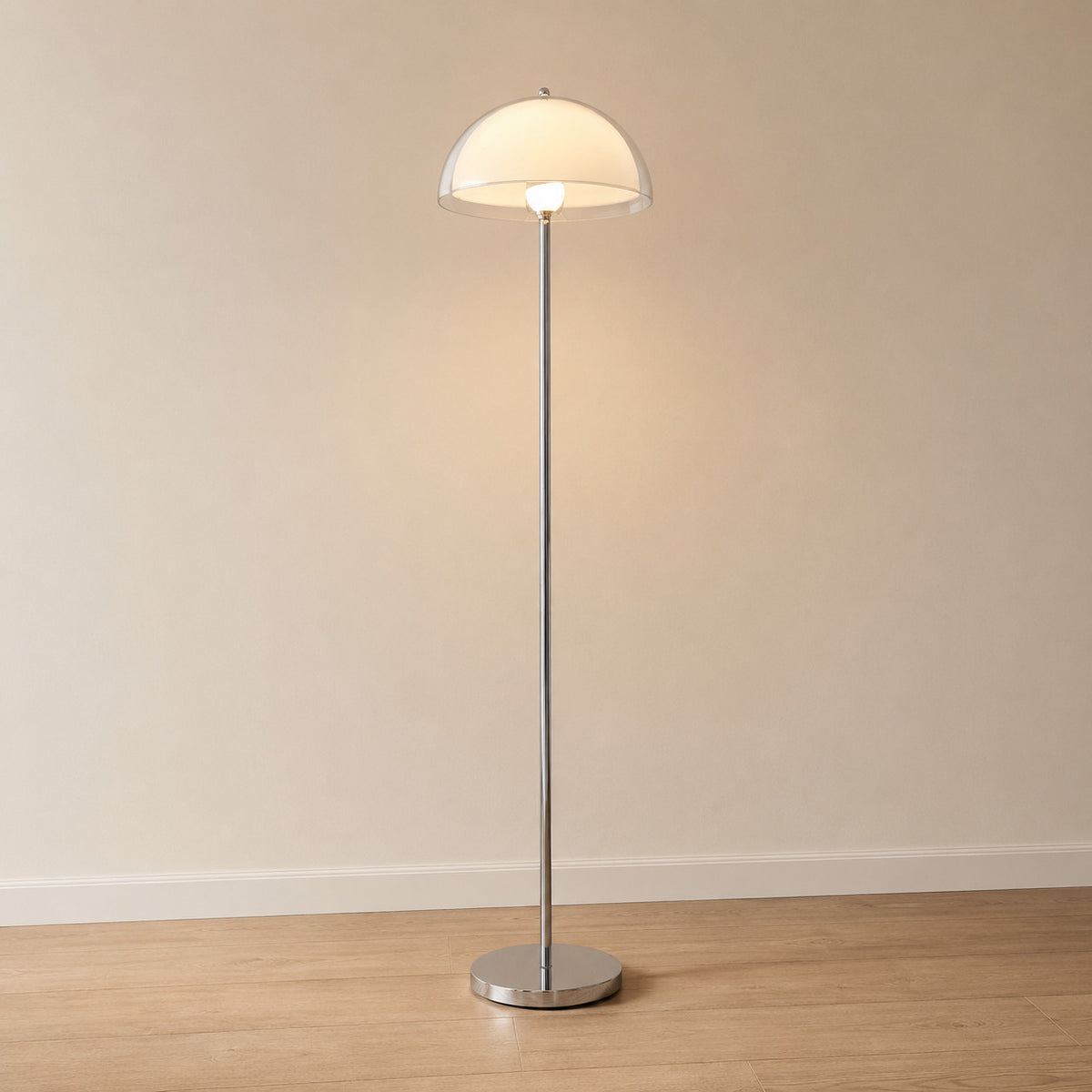 Benavente floor lamp with a warm cream off-white inner dome under a clear acrylic outer shade, chrome stem, 155 cm tall